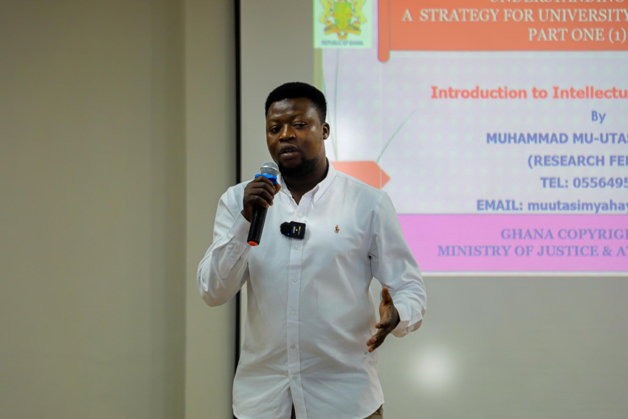 Speaker presenting research at a workshop in Ghana