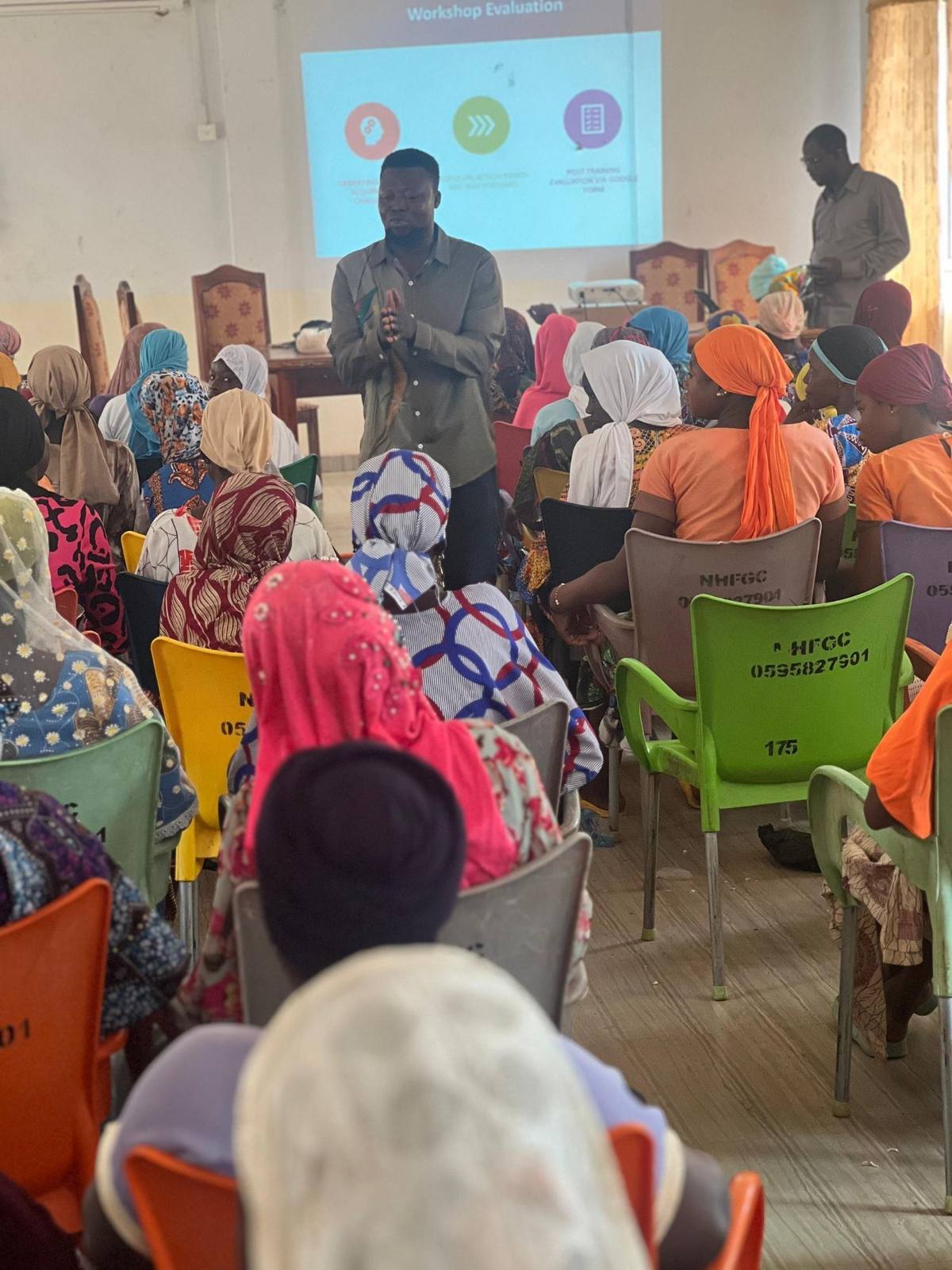Facilitator addressing women at a community workshop