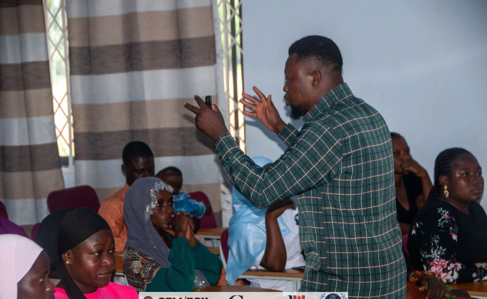 Facilitator gesturing during a community training session