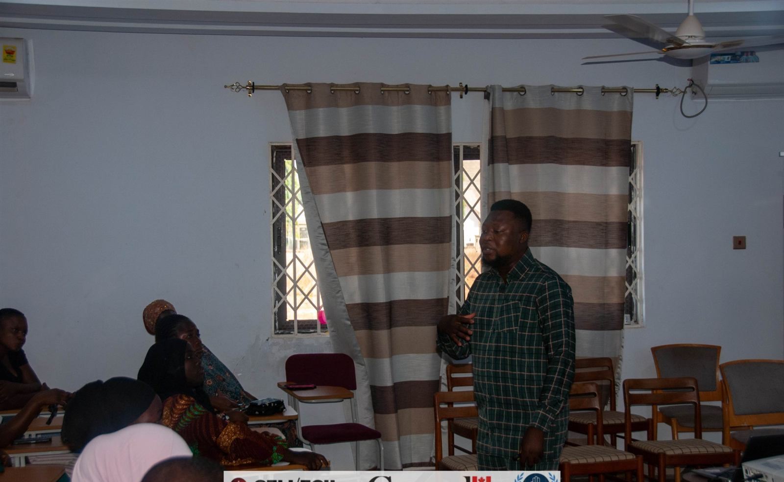 Trainer addressing participants in a workshop room