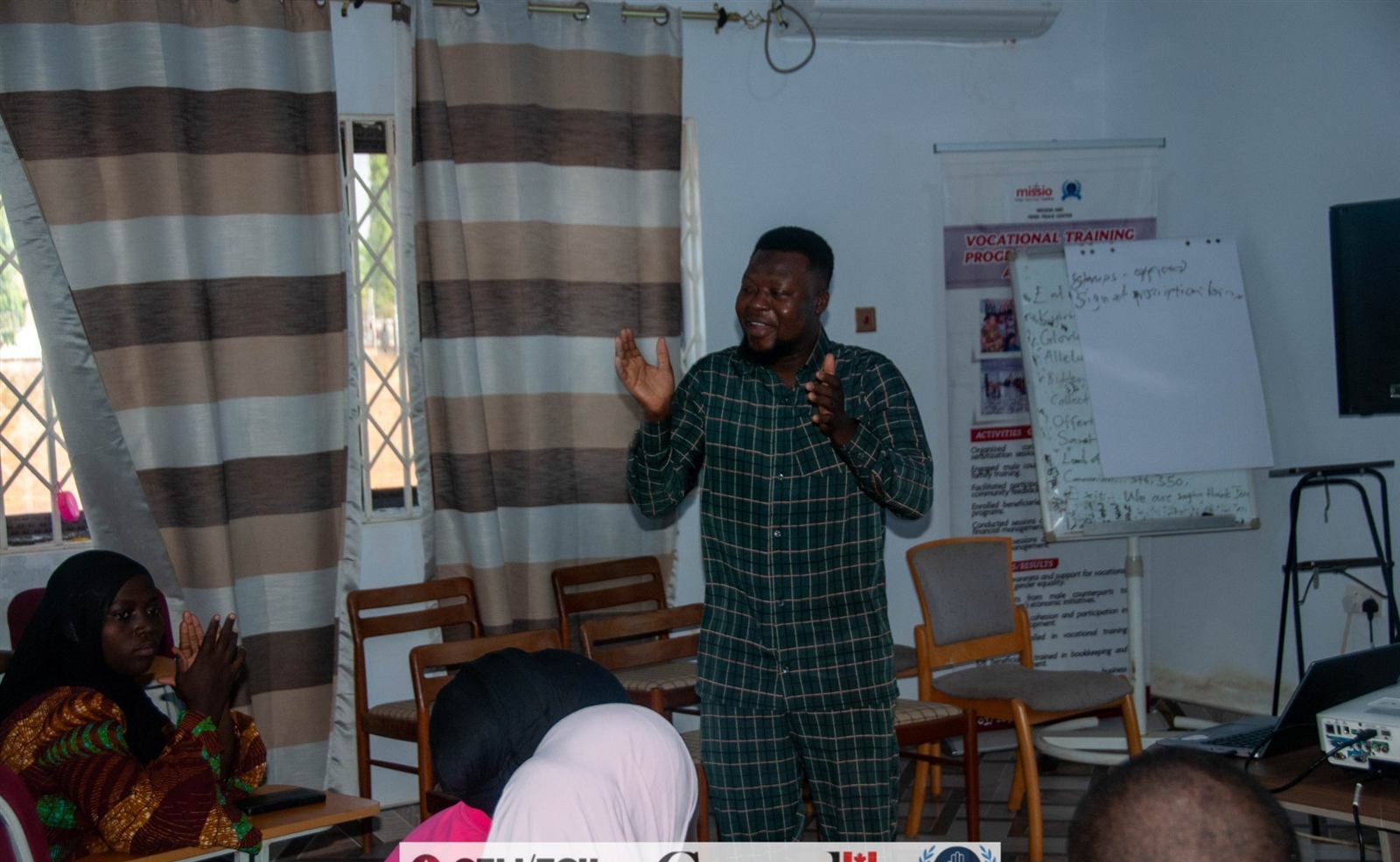 Facilitator standing beside flipchart presenting workshop findings